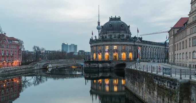Sunrise hyperlapse in central Berlin with Bode museum and TV tower in frame on a cloudy morning