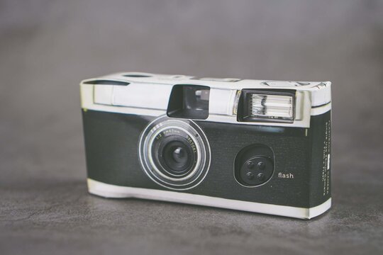The 35mm film disposable camera isolated on grey background 