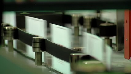 A Machine for Automatic Sorting of Mail Items is processing a Large Batch of Letters. Closeup. 
