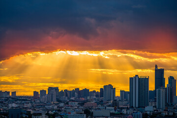 Fototapeta premium The blurred abstract background of the morning sun exposure to the tiny dust particles that surround the tall buildings in the capital, the long-term health issue of pollution