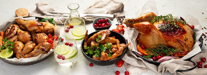 Assorted grilled chicken meat and sauce on gray background. Homemade food concept.