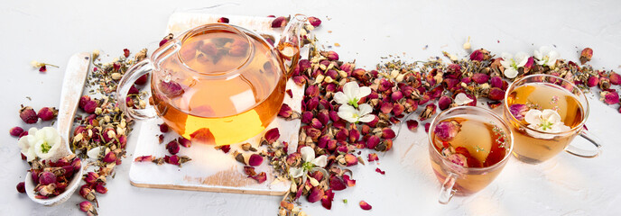 Rose tea with cups and teapot on light gray backround.