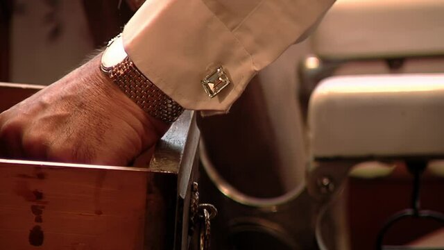 Barber picking up his Work Tools from Old Drawer at Beauty Salon. Close Up.