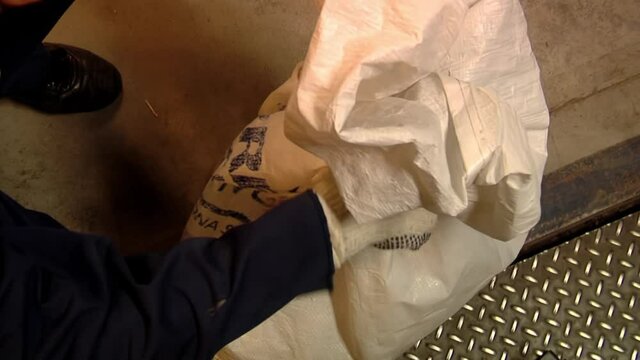 Postal Worker tying a Mail Bag of Argentine Post Service. Close Up. Top View. 