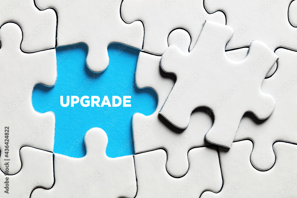 Poster the word upgrade on a missing puzzle piece. to upgrade a software or hardware