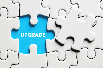 The word upgrade on a missing puzzle piece. To upgrade a software or hardware - obrazy, fototapety, plakaty