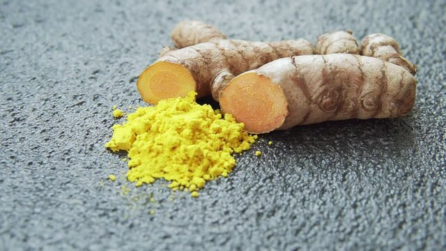 Fresh turmeric rhizome and powder. Yellow curcumin. Curcuma