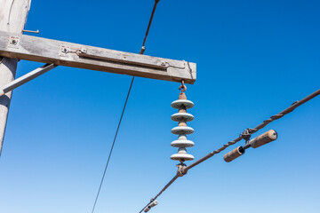 Drone aerial photograph of a wooden telephone pole and wires in a forest