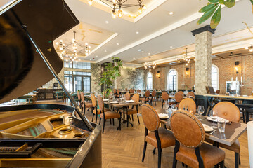 Interior of a modern hotel cafe restaurant with piano
