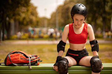 Roller skating girl in park rollerblading on inline skates. Caucasian young woman in outdoor activities.