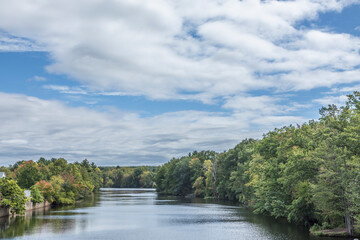 Fototapeta na wymiar James River at Wilbraham with trees and soft cloudy blue sky