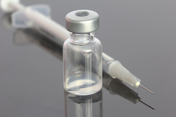 Vaccine vial with needle and syringe