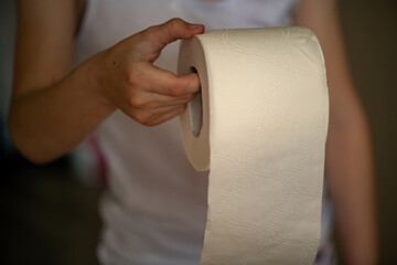 Child holding toilet paper at home 