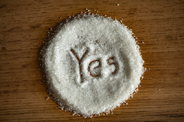 The hand-drawn word Yes to a pile of sugar 