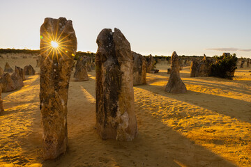 Sun shining through hole in stone monolith at the Pinnacles at Nambung National Park, Western Australia