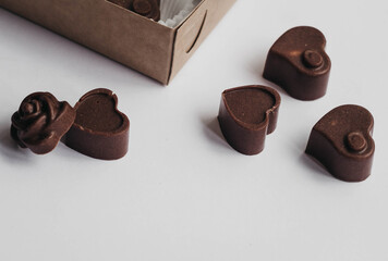 Milk chocolate pieces isolated on white background from top view