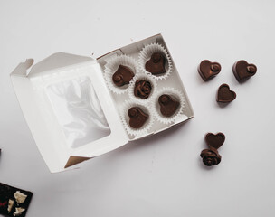 Milk chocolate pieces isolated on white background from top view