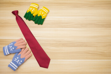 Represent scene of daughter and son gives red tie gift to dad by unbranded gloves at left side with wood background