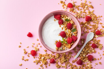 Bowl with greek yogurt, raspberries and granola. Top view flat lay. Healthy food, snack, breakfast.