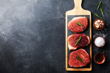Raw beef meat on kitchen board. Top view flat lay with copy space