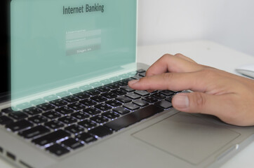 hand is typing the computer keyboard on virtual screen internet banking.Business finance technology concept