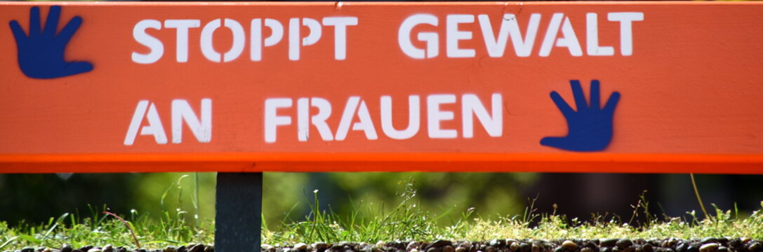 Auf eine orange Holzbank gesprayt: "Stoppt Gewalt an Frauen"
