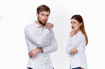 a business man in a shirt and a woman employee on a light background are gesturing with their partners hands