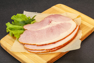 Sliced pork belly over board