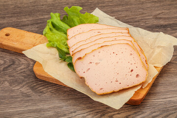 Boiled pork sausage over board