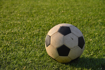 Fototapeta premium Vintage football ball on green grass player field