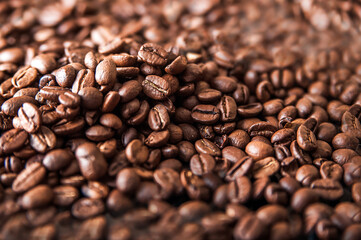 Coffee background close-up macro. Lots of coffee beans and copy space.