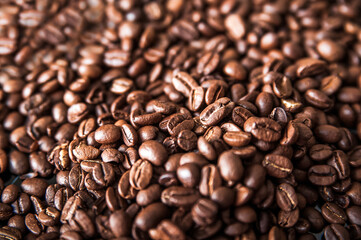 Coffee background close-up macro. Lots of coffee beans and copy space.