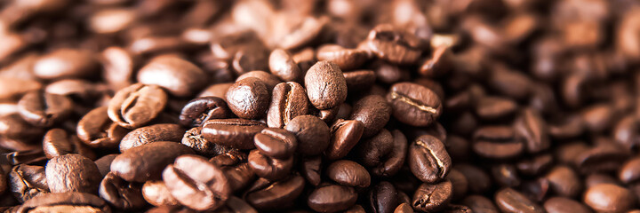 Coffee background close-up macro. Lots of coffee beans and copy space.