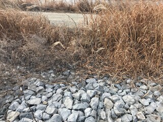 A stone cape next to a country road.