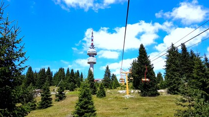 Empty chair lift ascending in Pamporovo winter mountain ski resort in Bulgaria during summer.
