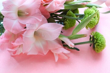mockup greeting card. bouquet of pink gladioli on pink background and space for text 