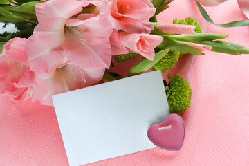 mockup greeting card. bouquet of pink gladioli on pink background and space for text 