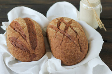 Art bread. Delicious fresh homemade sourdough art bread, sourdough starter in a glass jar