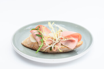 mortadella bruschetta with pesto and arugula