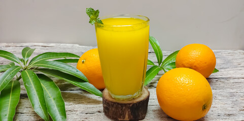 Closeup of Fresh Orange or tangerine juice in a wooden background with copy space. Summer. Refreshment. Fresh Juice.
