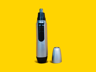 Opened Nose Trimmer isolated on yellow background. Front side standing position. Black and silver color.