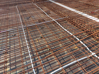 KUALA LUMPUR, MALAYSIA -NOVEMBER 23, 2020: Building floor slab under construction. Construction workers fabricating the timber formwork and installing the steel reinforcement bar. 

