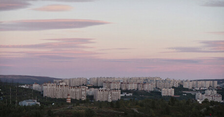 Fototapeta na wymiar Sunset and sky over multi-storey buildings in Murmansk