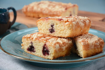 German cherry cake with vanilla and icing sugar, with glaze, served and sliced on plate