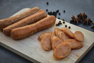 Sausage Or Guan Chiang and Herbs on the board, serving good beer snacks on a dark background.