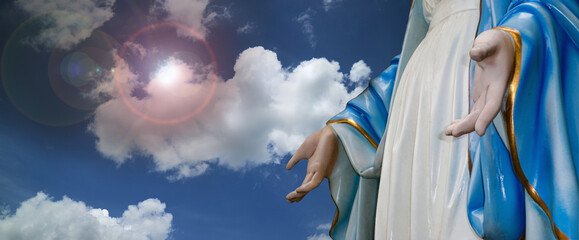 Saint Mary statue with lens flare effect on blue sky religion,mother of Jesus, © Phaitoon