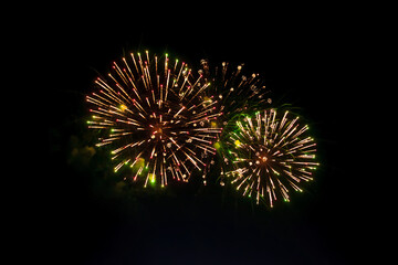 Bright fiery fireworks against the dark night sky. Abstract colorful beautiful fireworks salute...