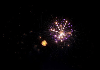 Bright fiery fireworks against the dark night sky. Abstract colorful beautiful fireworks salute...