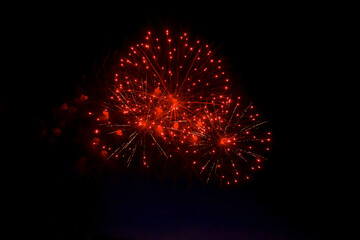 Bright fiery fireworks against the dark night sky. Abstract colorful beautiful fireworks salute...