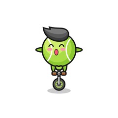 Obraz premium The cute tennis character is riding a circus bike